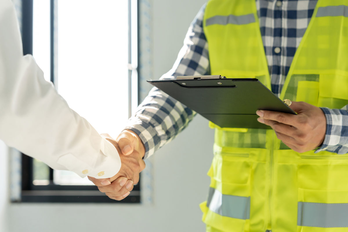 A certified fire door inspector in Norwich from SAB Group is meeting the Responsible Person for Fire Safety